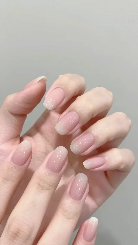 Graceful oval nails on short fingers, soft light