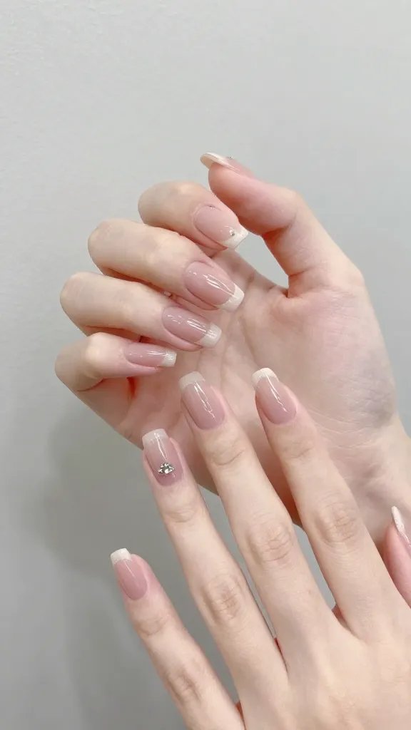 Dainty hand, graceful nails, elegant pose.