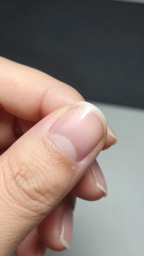 Closeup: single nail, dried polish divot.